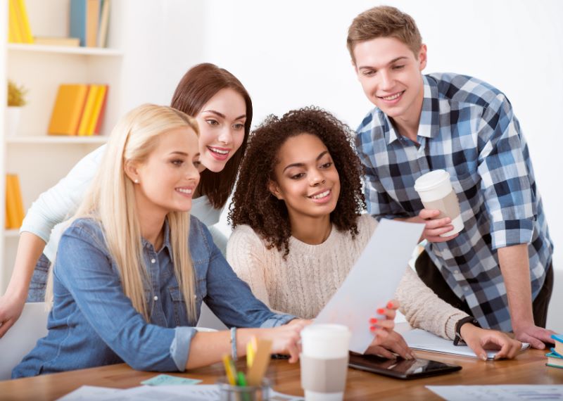 a-group-of -people-looking-at-a-piece-of-paper
