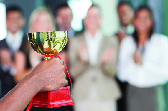 a-close-up-of-a-hand-holding-a-trophy